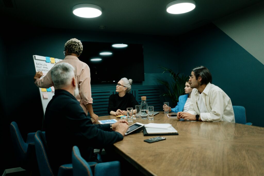 Diverse team discussing business strategy during a meeting in a modern office setting.